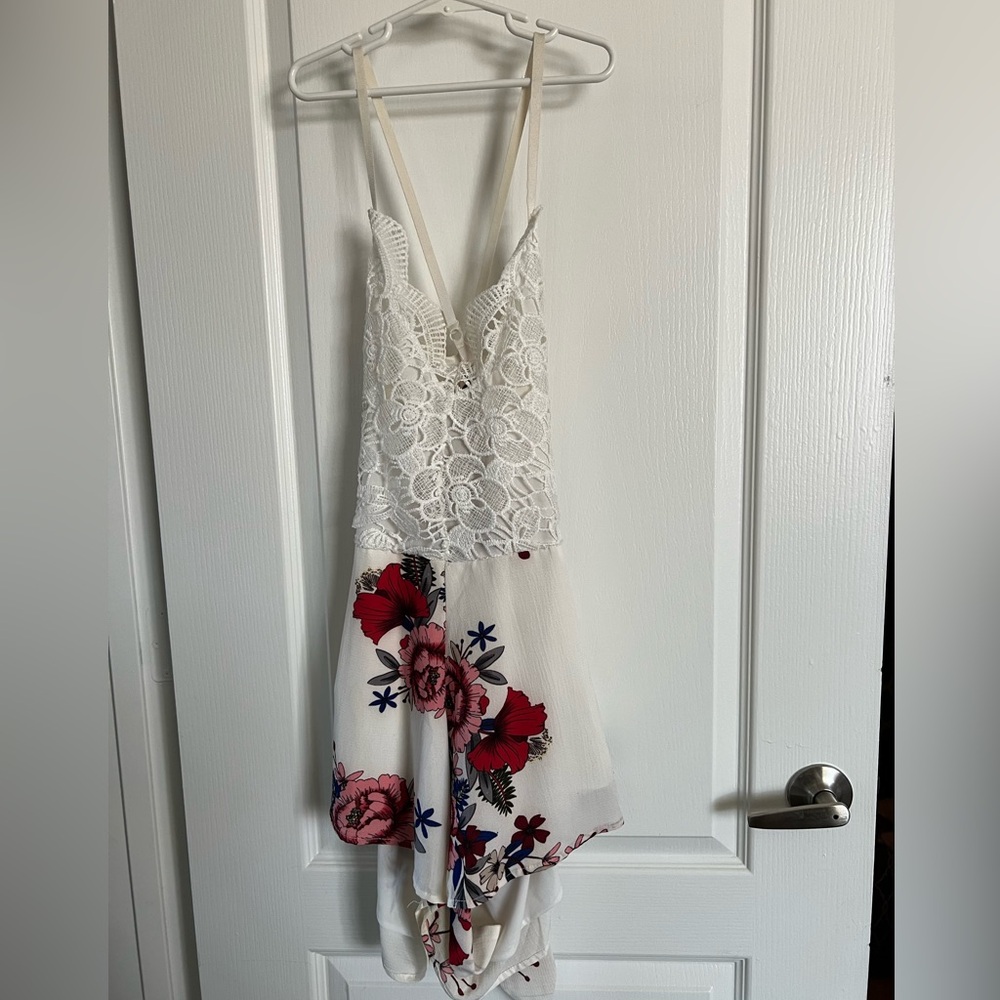 White and floral romper. Ties in the back